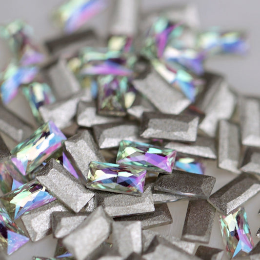 Flatback Zircon Nail Art Baguette Paradise Shine crystals measuring 4×2mm with iridescent pink, purple, green, yellow, aqua and blue reflections.