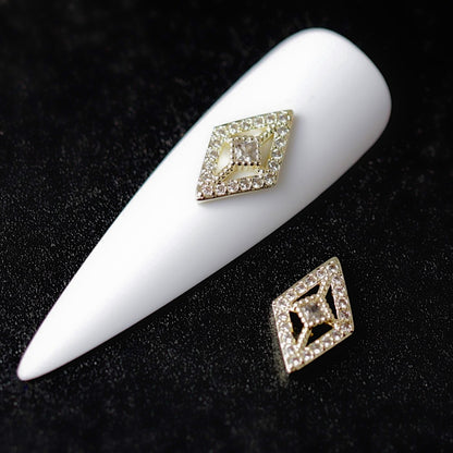 Crystal CZ rhombus nail charm with clear cubic zirconia stones, a larger centre crystal and gold-tone geometric details.
