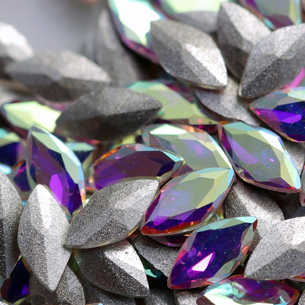 Faceted Crystal AB glass navette stones with rainbow reflections and a slightly curved back.