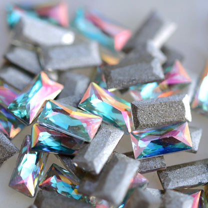 Flatback Zircon Nail Art Baguette Crystal AB crystals measuring 4×2mm with iridescent pink, lilac, aqua, blue, green and champagne reflections.