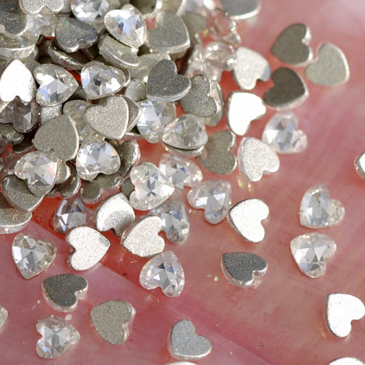 Group of precision faceted heart zircon flatbacks in crystal clear with high brilliance and durable flatback design for bridal and fashion nails