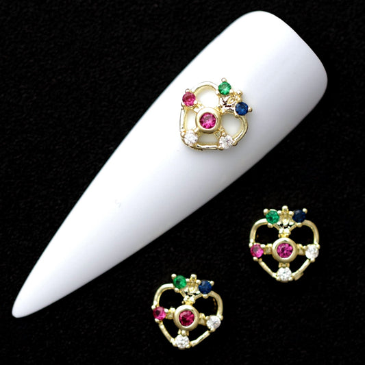 8 mm crown-topped heart nail charms with pink, green, blue and crystal CZ stones displayed on a white nail tip against a black background