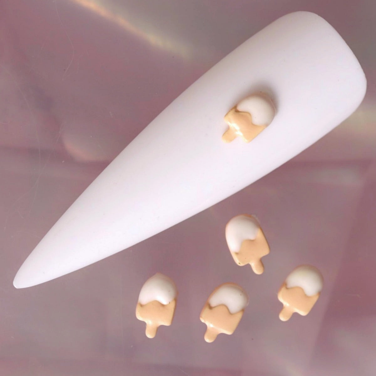 Three-dimensional ice cream nail charm with a smooth beige base and creamy white dripping topping. This cute summer decoration is ideal for dessert-themed manicures, kawaii nail art, food-inspired designs and playful accent nails.