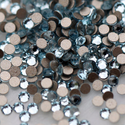 Round K9 flatback rhinestones in Aquamarine with faceted light blue tops for nail art