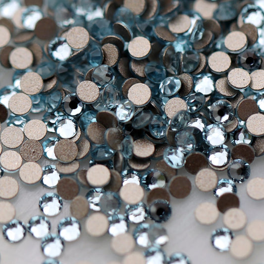 Round K9 flatback rhinestones in Aquamarine with faceted light blue tops for nail art