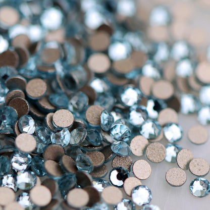 Round K9 flatback rhinestones in Aquamarine with faceted light blue tops for nail art
