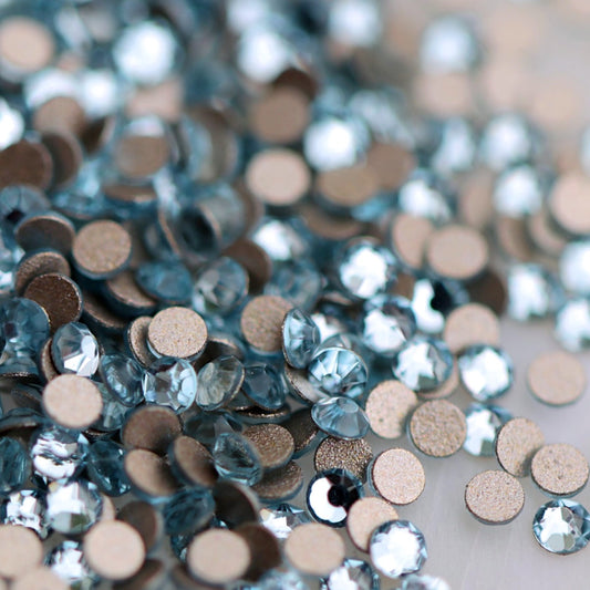 Round K9 flatback rhinestones in Aquamarine with faceted light blue tops for nail art
