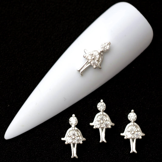 Silver ballerina nail charms with crystal CZ head and pavé tutu on a white nail tip against a black background